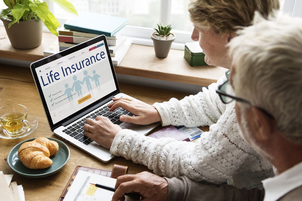 An older couple signing up for life insurance