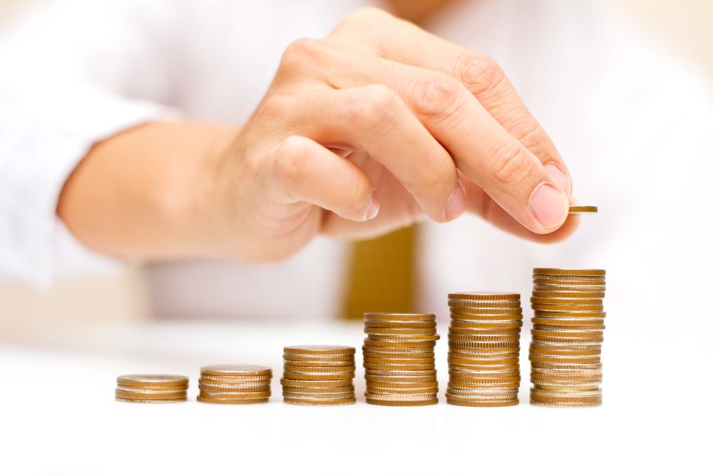 A man stacking coins