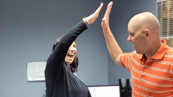 Danielle and David, Social Workers at Mannor Law Group, celebrate after helping a family with a nursing facility placement struggle