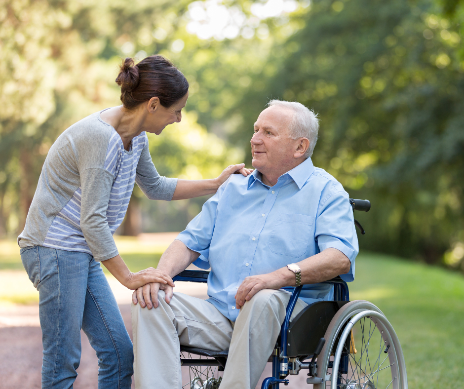 A women talking to a man in a wheelchair
