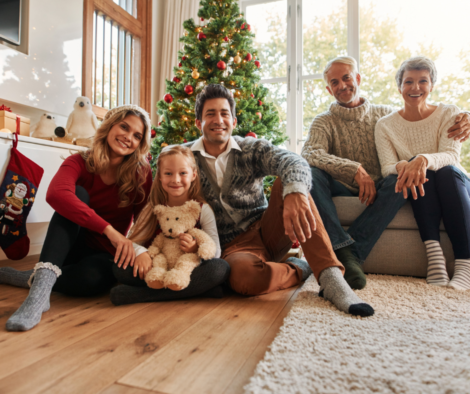 family in front of holiday tree