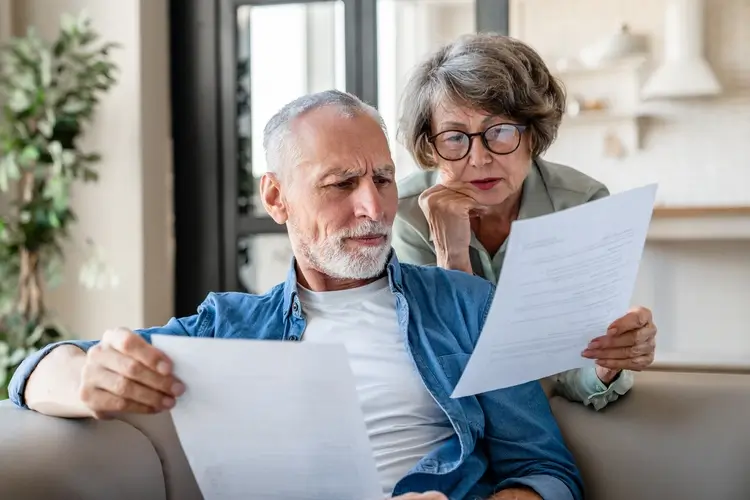 Elderly couple reviewing documents