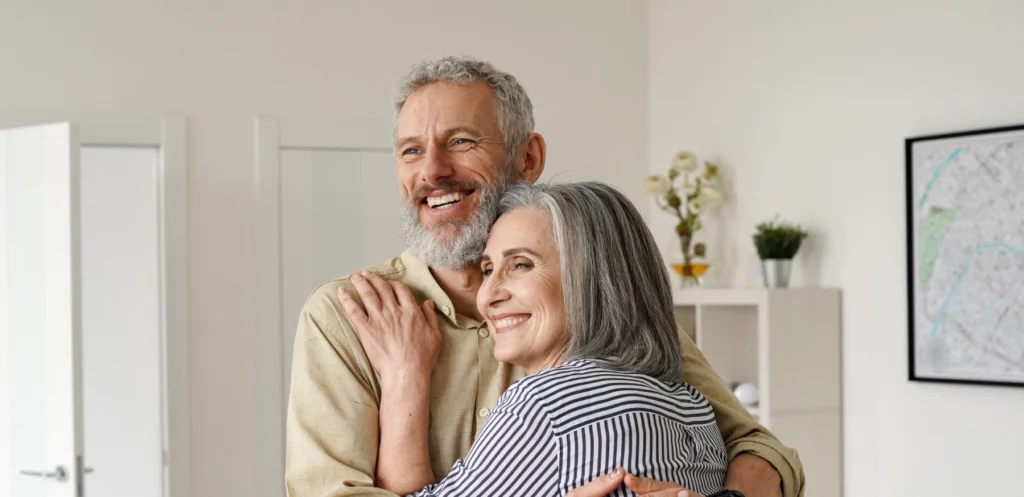 happy elderly couple hugging