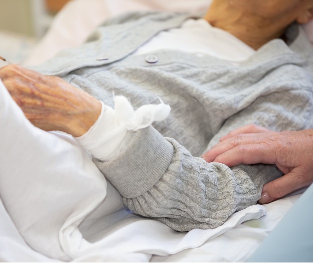 elderly woman laying in bed